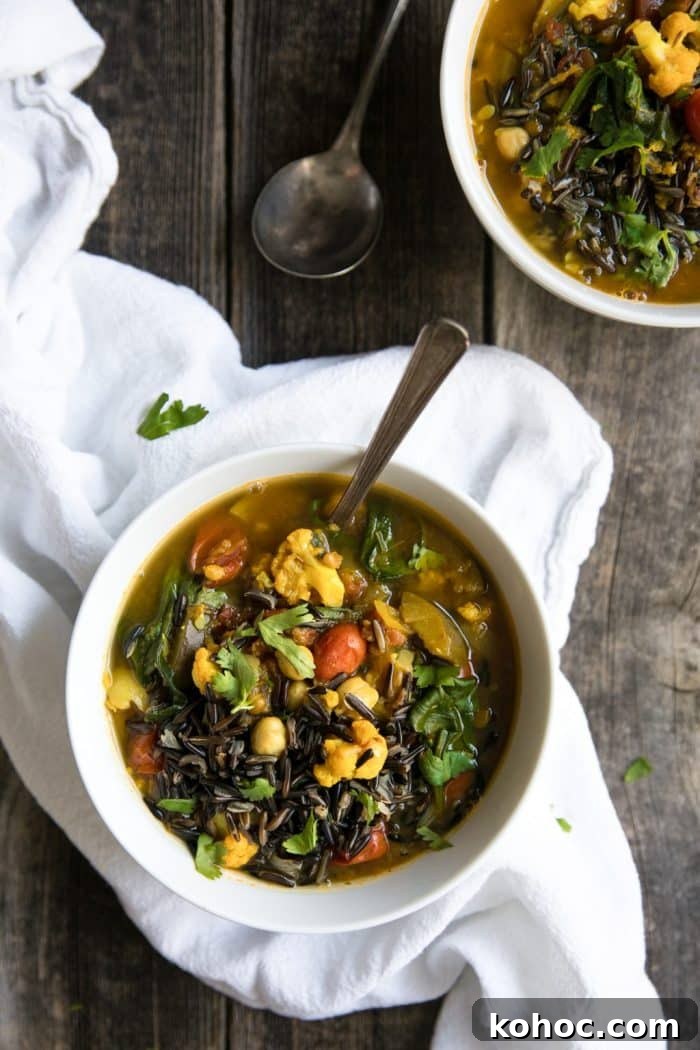 Turmeric Vegetable and Wild Rice Broth Soup 5 White bowls filled with vegetables, lentils, garbanzo beans, and wild rice, and fresh cilantro.