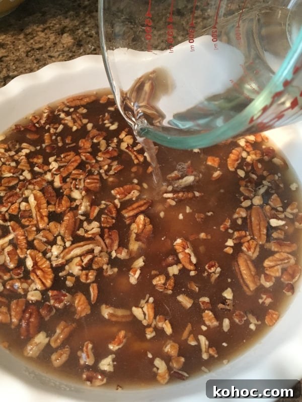 Irresistible Pumpkin Cobbler Recipe for Fall Gatherings 7 hot water being added to top of pumpkin cobbler prior to baking