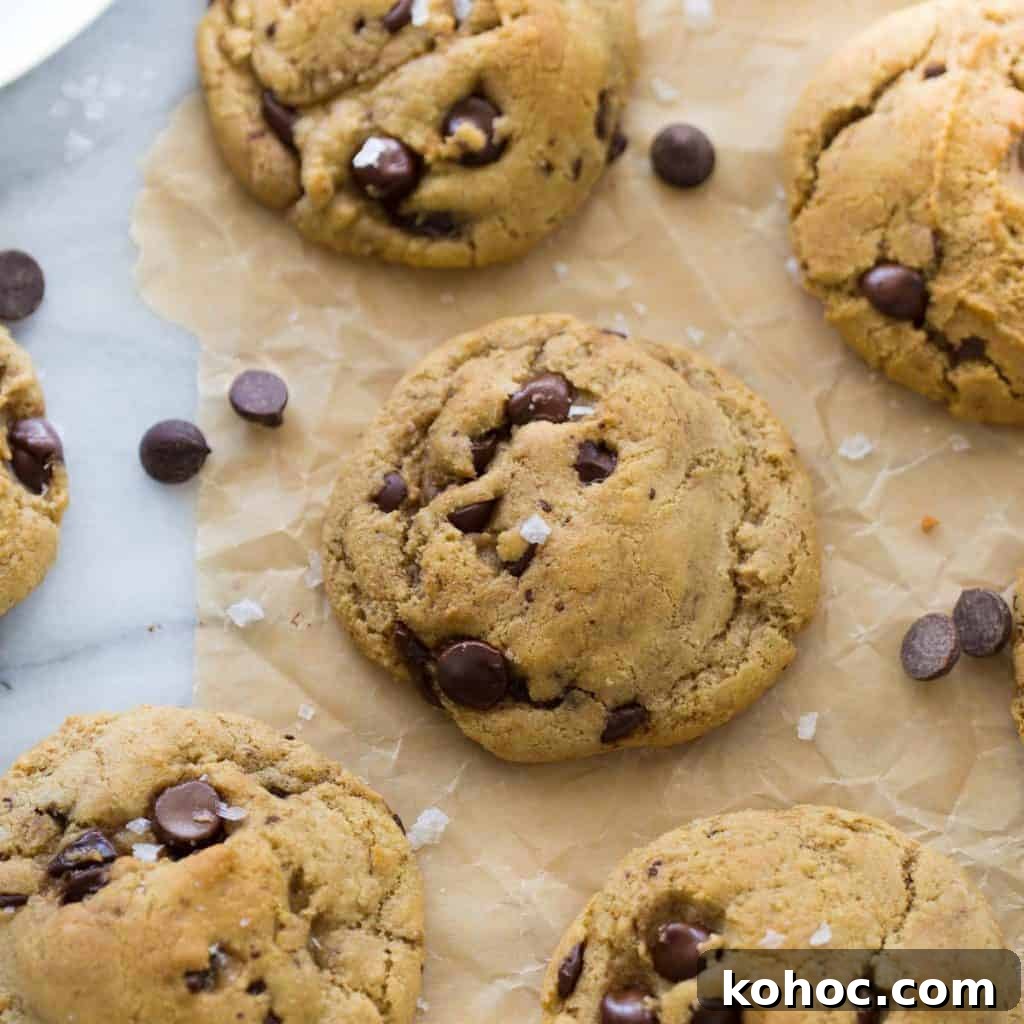 Are Chocolate Chips Gluten-Free? What You Need to Know 3 chocolate chip cookies topped with sea salt on brown parchment paper