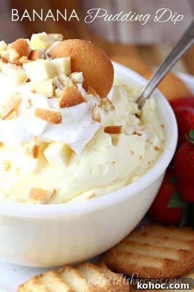 White bowl of banana pudding dip garnished with Vanilla wafers.
