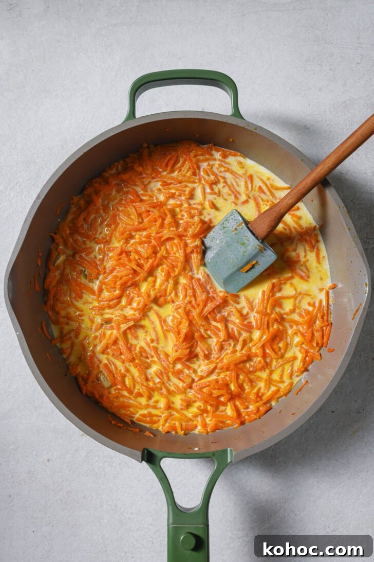 Whole milk and cream added to sautéed carrots and mixed in.