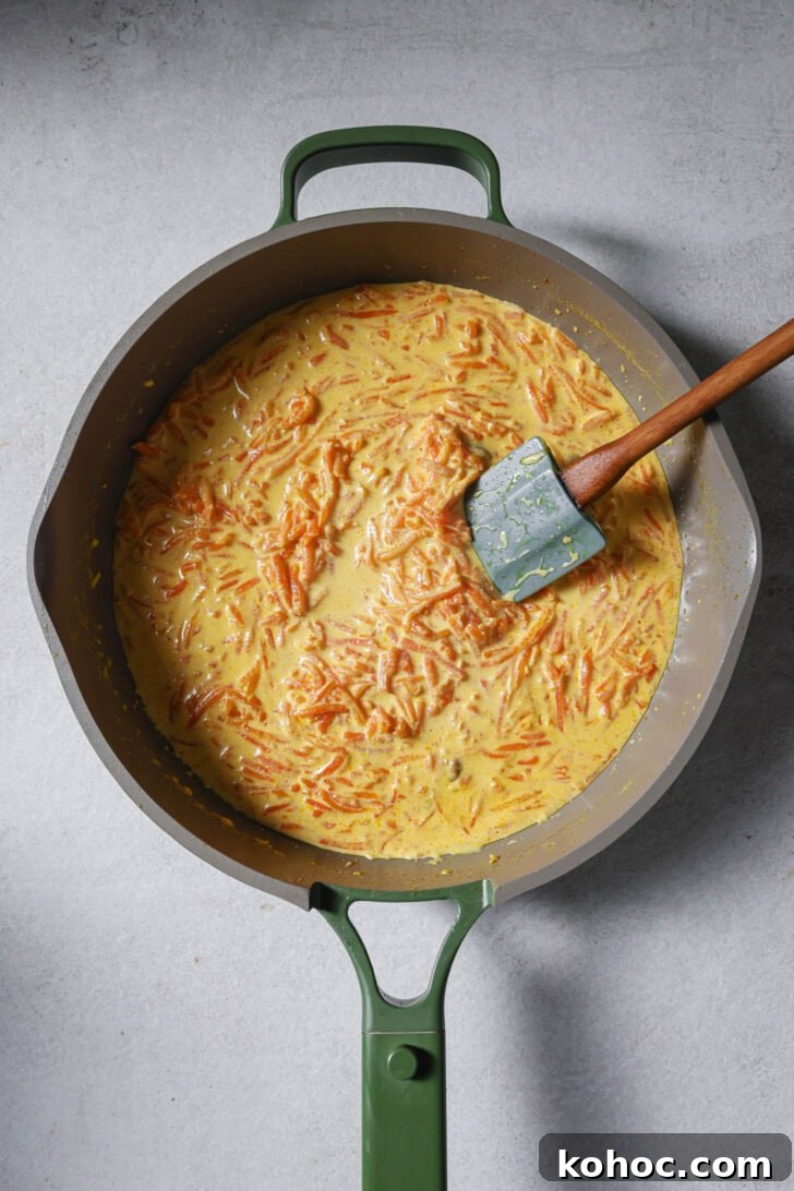 Cooking carrot and milk mixture in a skillet.