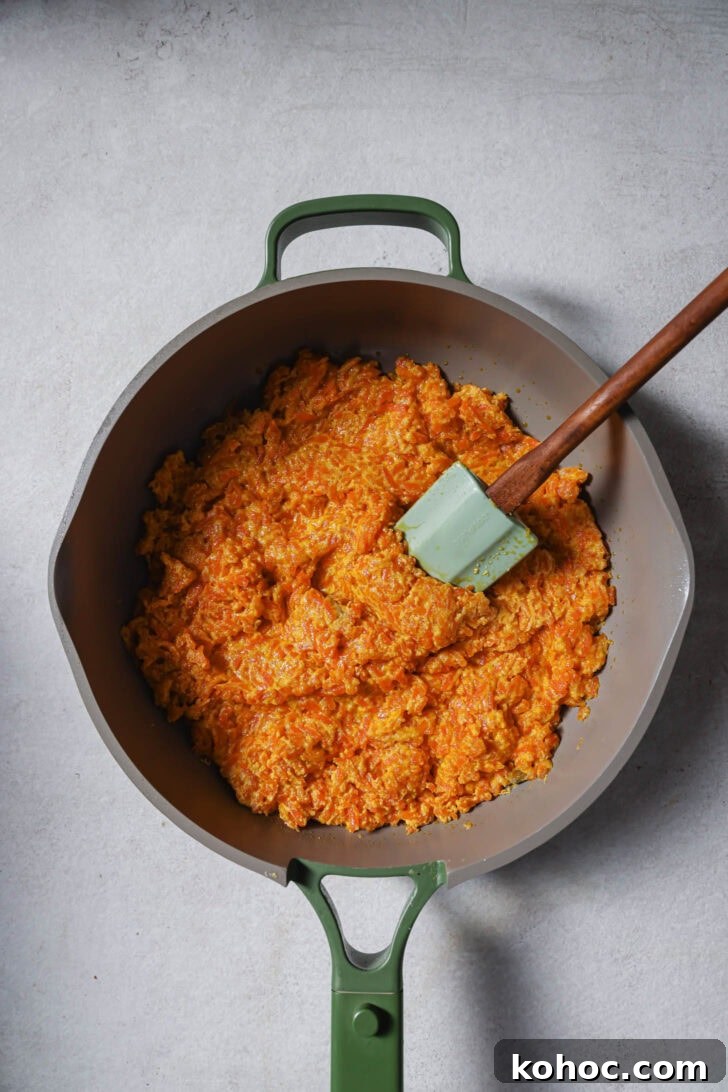 Cooking carrot mixture with sugar to make Carrot Halwa.