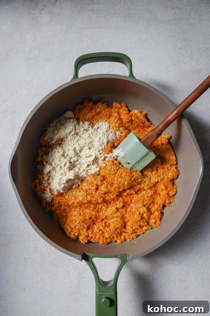 Dry milk powder added to carrot mixture to make Carrot Halwa.