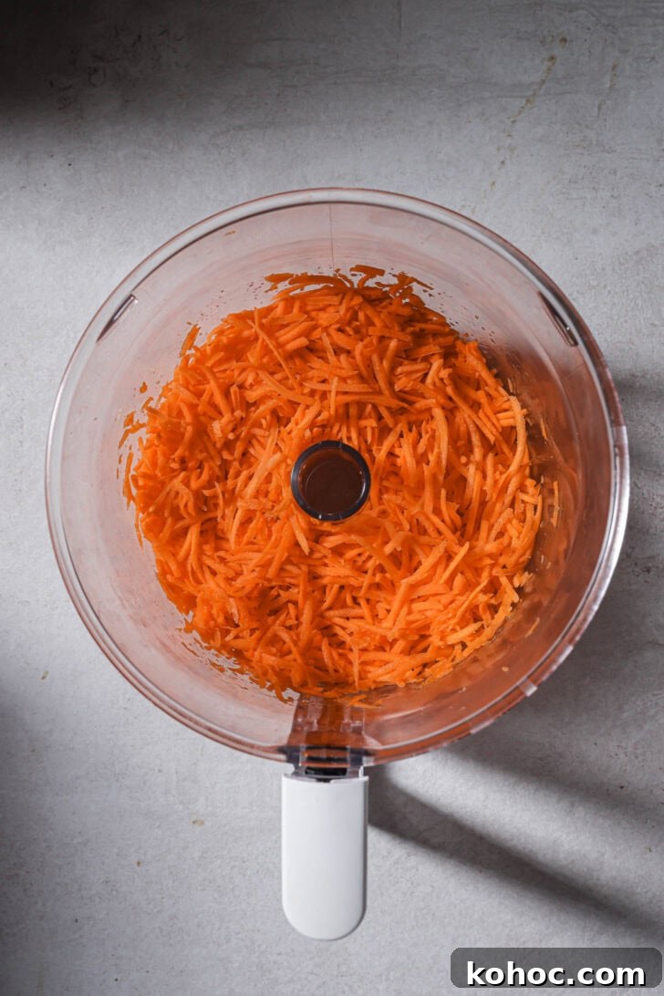 Shredded carrots in a food processor.