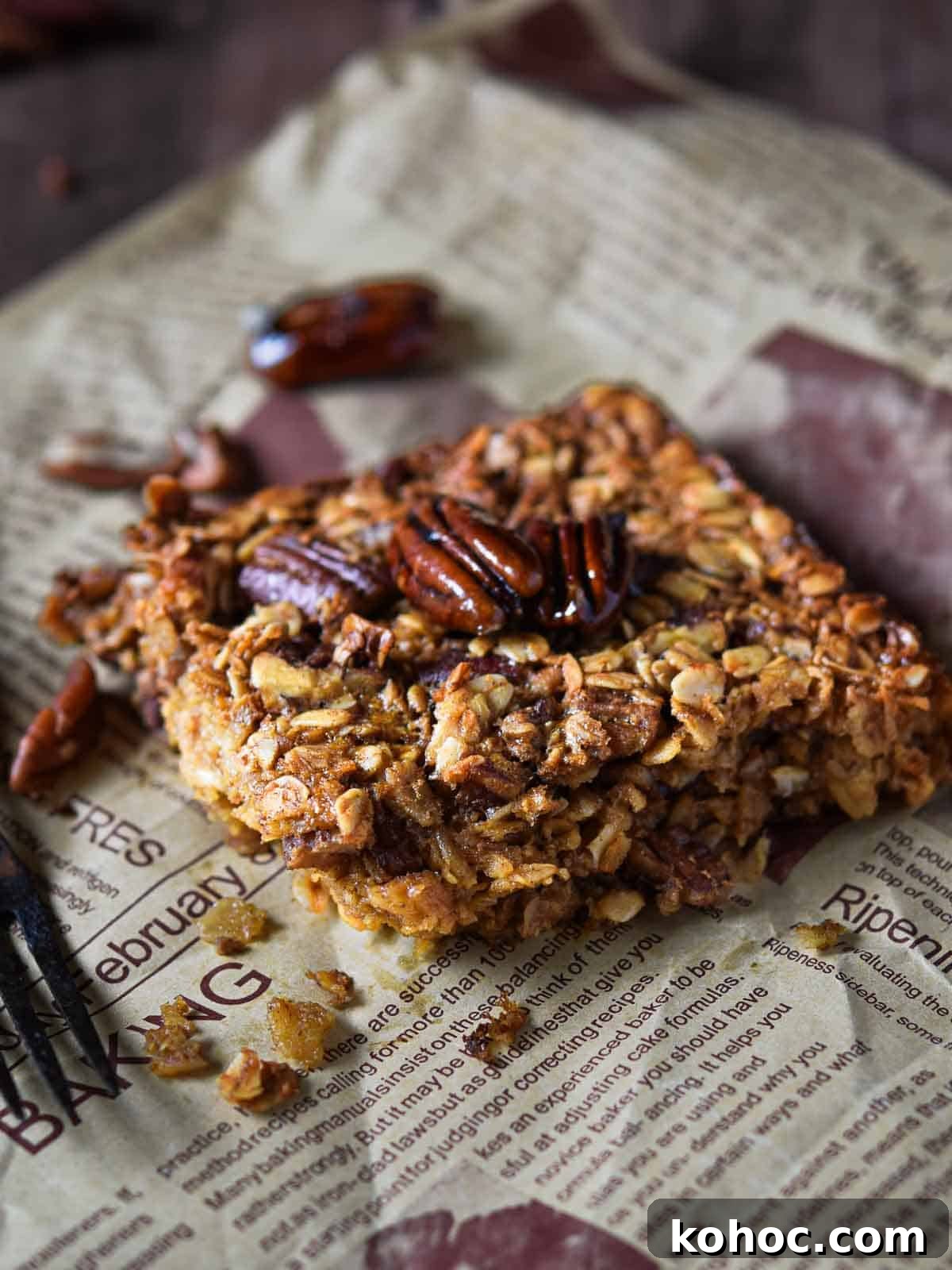 Baked oatmeal with pecans on brown parchment paper.