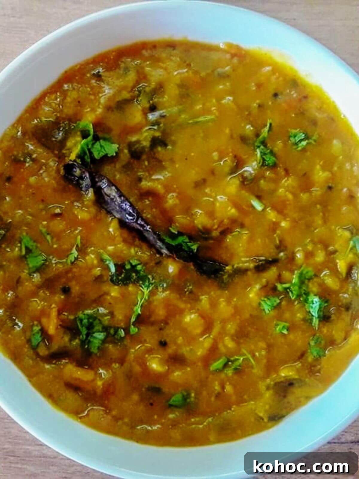 Restaurant-Style Dal Fry Recipe: Ready in 30 Minutes 2 close-up of dal fry in a white bowl.
