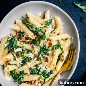 Creamy Pancetta Pasta with Parmesan and Peas 12 Pancetta Pasta served in a white bowl and photographed from the top.