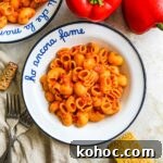 Roasted Red Pepper Pesto Pasta Recipe for Flavorful Weeknights 11 Roasted red pepper pesto pasta in a bowl with roasted red bell pepper and parmigiano-reggiano.