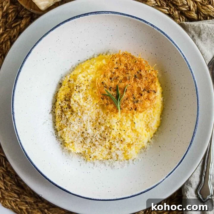 Creamy polenta with parmigiano-reggiano, rosemary, and frico (montasio cheese crisps) in a bowl.