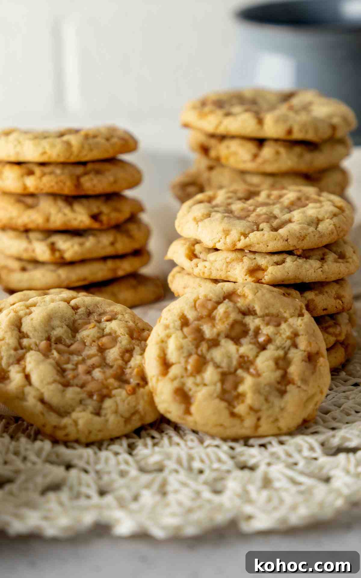 A stack of cookies with toffee pieces melted on top of them.