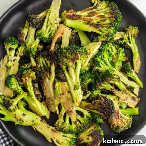 Blackstone Grilled Corn on the Cob in the Husk - Juicy BBQ Flavor 11 Roasted Broccoli on a plate.