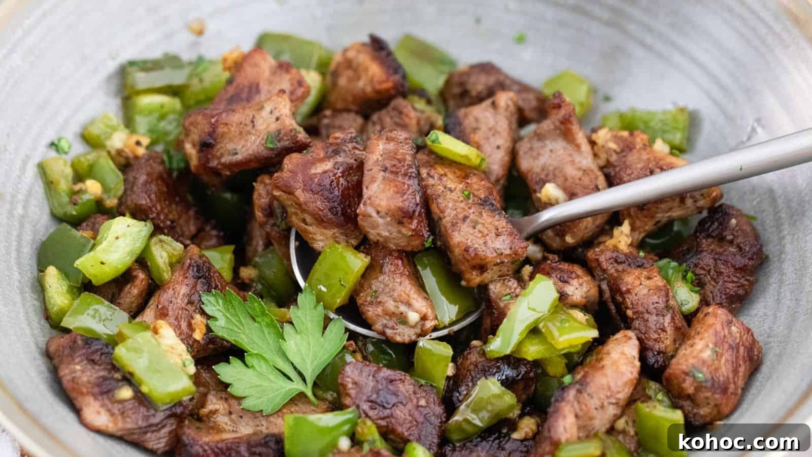 25 Skillet Meals Ready in 30 Minutes or Less 4 A bowl of meat and green peppers with a spoon.