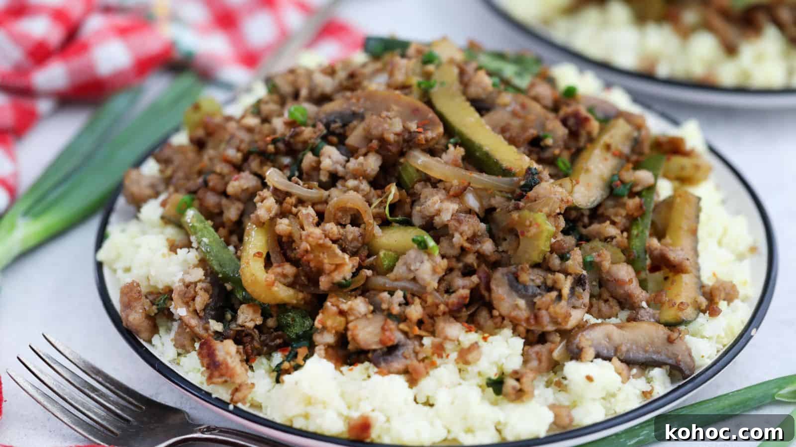 25 Skillet Meals Ready in 30 Minutes or Less 9 A plate with ground pork and vegetables on top of cauliflower rice.
