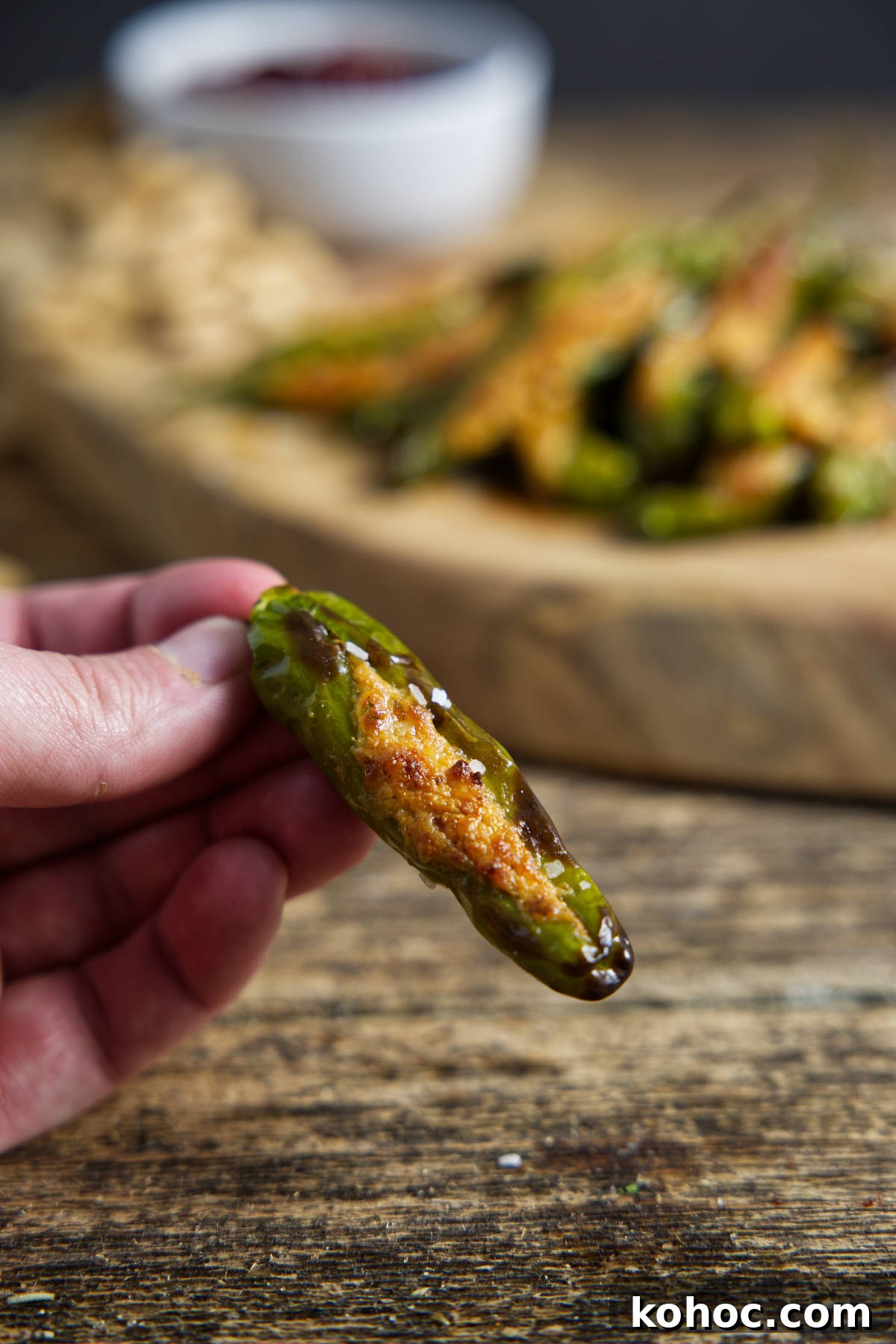 Crispy Air Fryer Shishito Peppers with Zesty Lemon Dip 11 single stuffed shishito pepper with charred and blistered skin, stuffed with cheese