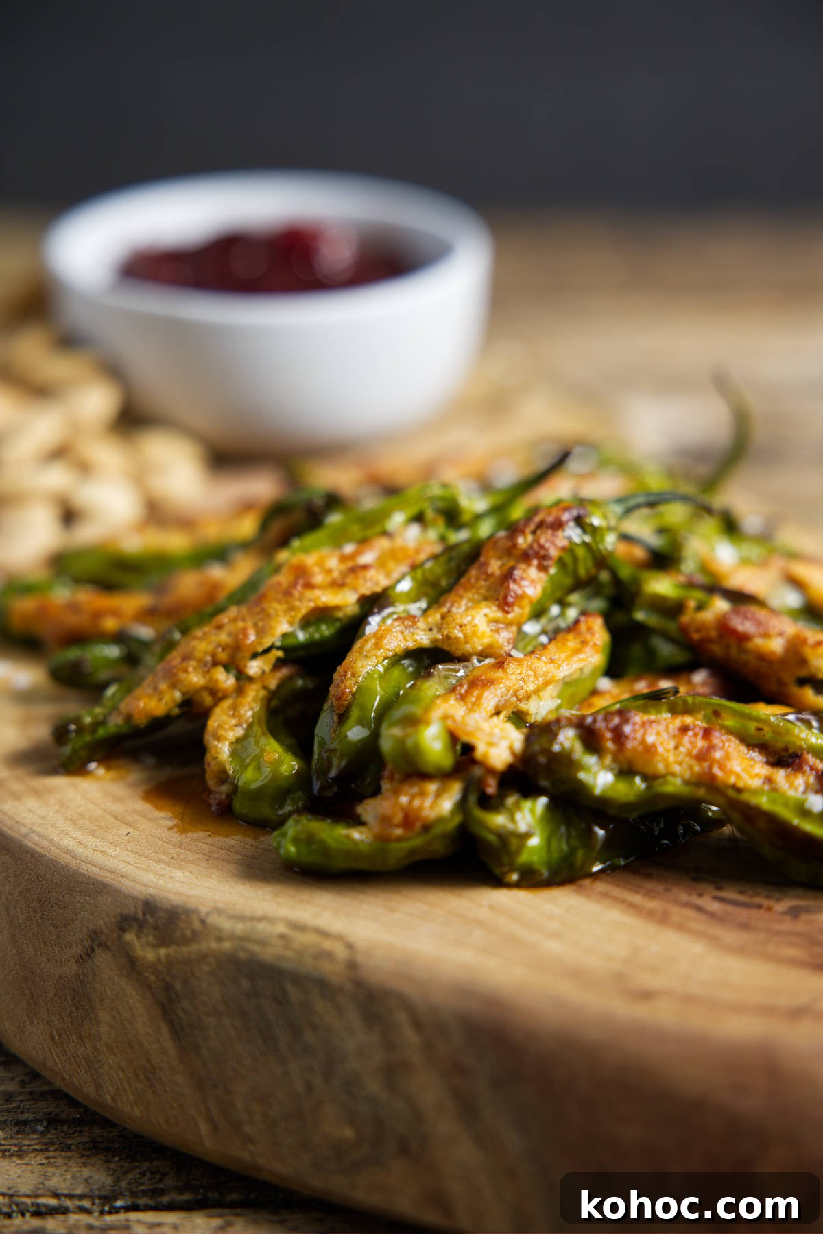 Crispy Air Fryer Shishito Peppers with Zesty Lemon Dip 3 air fryer shishito peppers in a pile on a cutting board