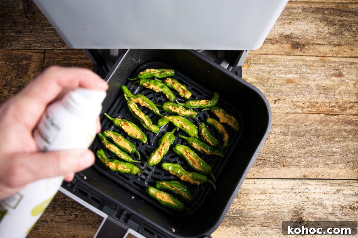 Crispy Air Fryer Shishito Peppers with Zesty Lemon Dip 8 stuffed shishito peppers in an air fryer basket