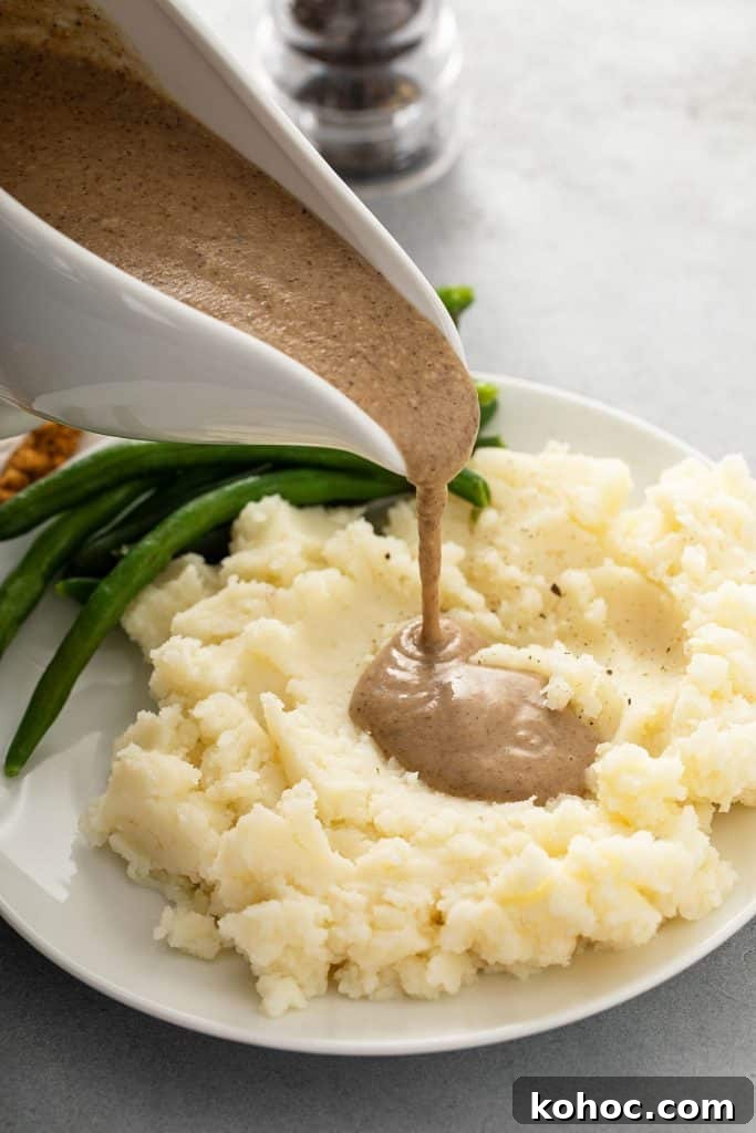 Savory Mushroom Vegan Gravy Recipe for Holiday and Everyday Meals 2 Pouring mushroom gravy over mashed potatoes