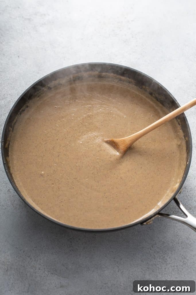 Savory Mushroom Vegan Gravy Recipe for Holiday and Everyday Meals 11 Smooth and glossy vegan gravy in a skillet