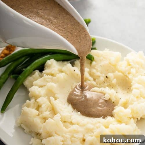 Savory Mushroom Vegan Gravy Recipe for Holiday and Everyday Meals 13 Pouring mushroom gravy over mashed potatoes