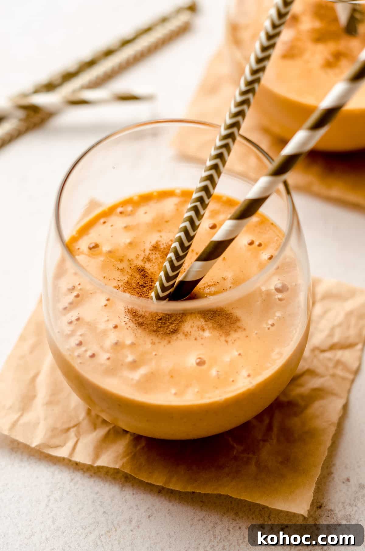 pumpkin pie smoothie in a glass with straws