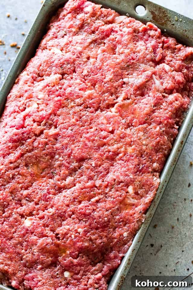 Make this juicy yet easy meatloaf recipe with a ketchup glaze, prepared with ground beef chuck and stuffed with cheese—it’s irresistibly good! Easy Meatloaf Recipe - Stuffed with feta cheese and topped with a delicious sweet and tangy glaze.