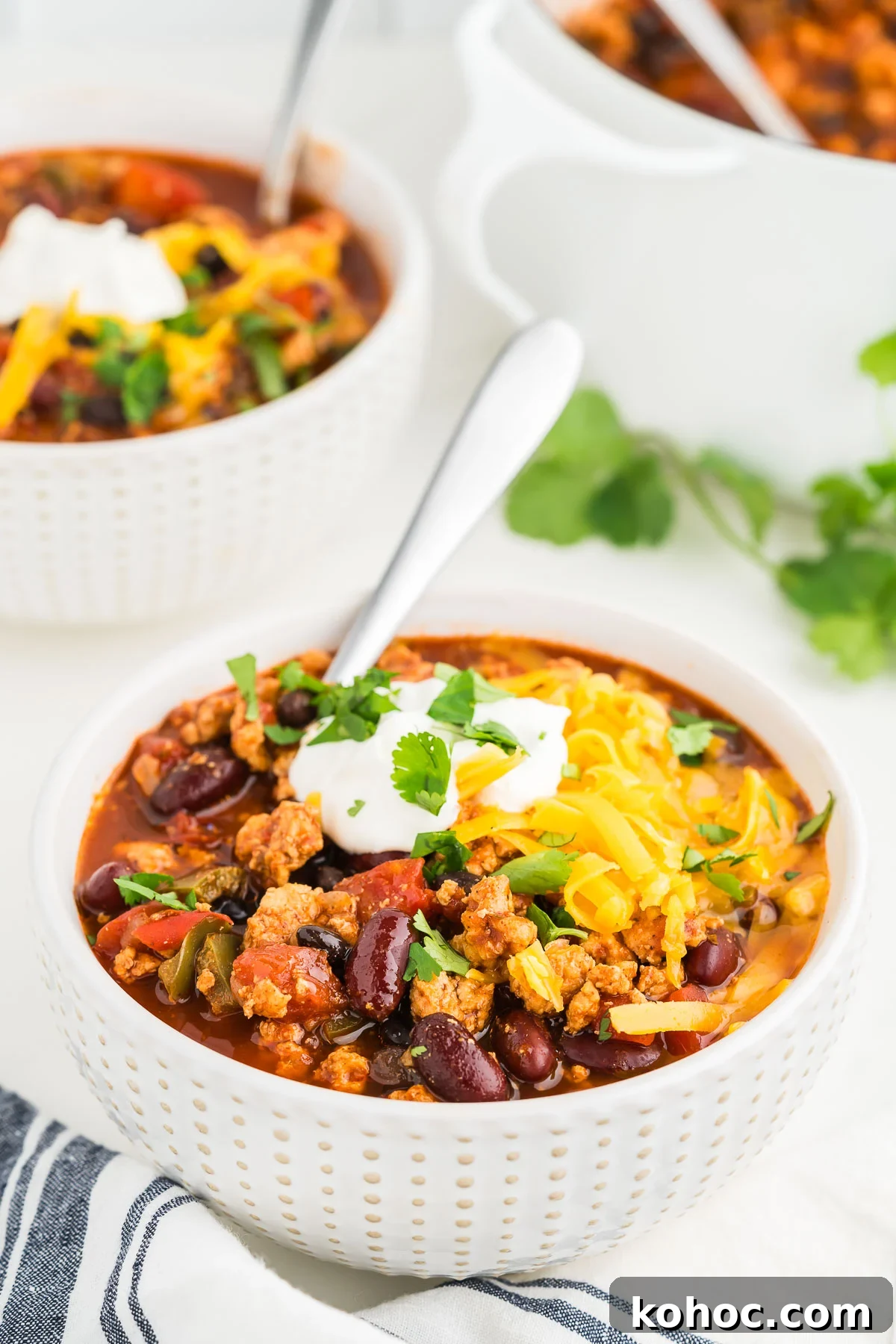 Hearty Ground Chicken Chili Recipe for Weeknight Dinners 8 closeup of ground chicken chili with cheese and cilantro