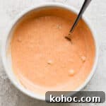 How to Make Classic Big Mac Sauce at Home 8 Top down shot of bowl of big mac sauce with a spoon sticking out.