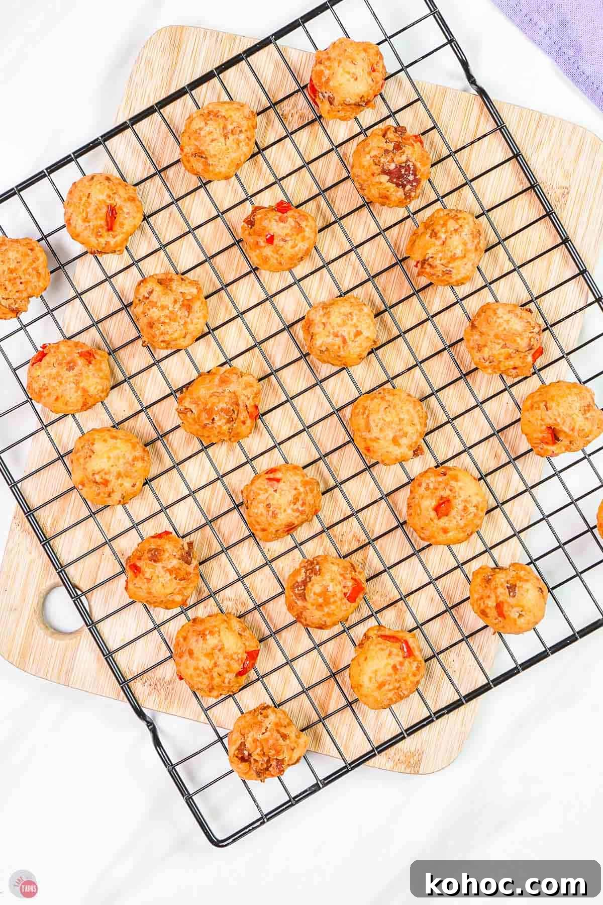 Pimento Cheese Sausage Balls: Southern Party Appetizer Recipe 6 baked sausage balls on a wire rack