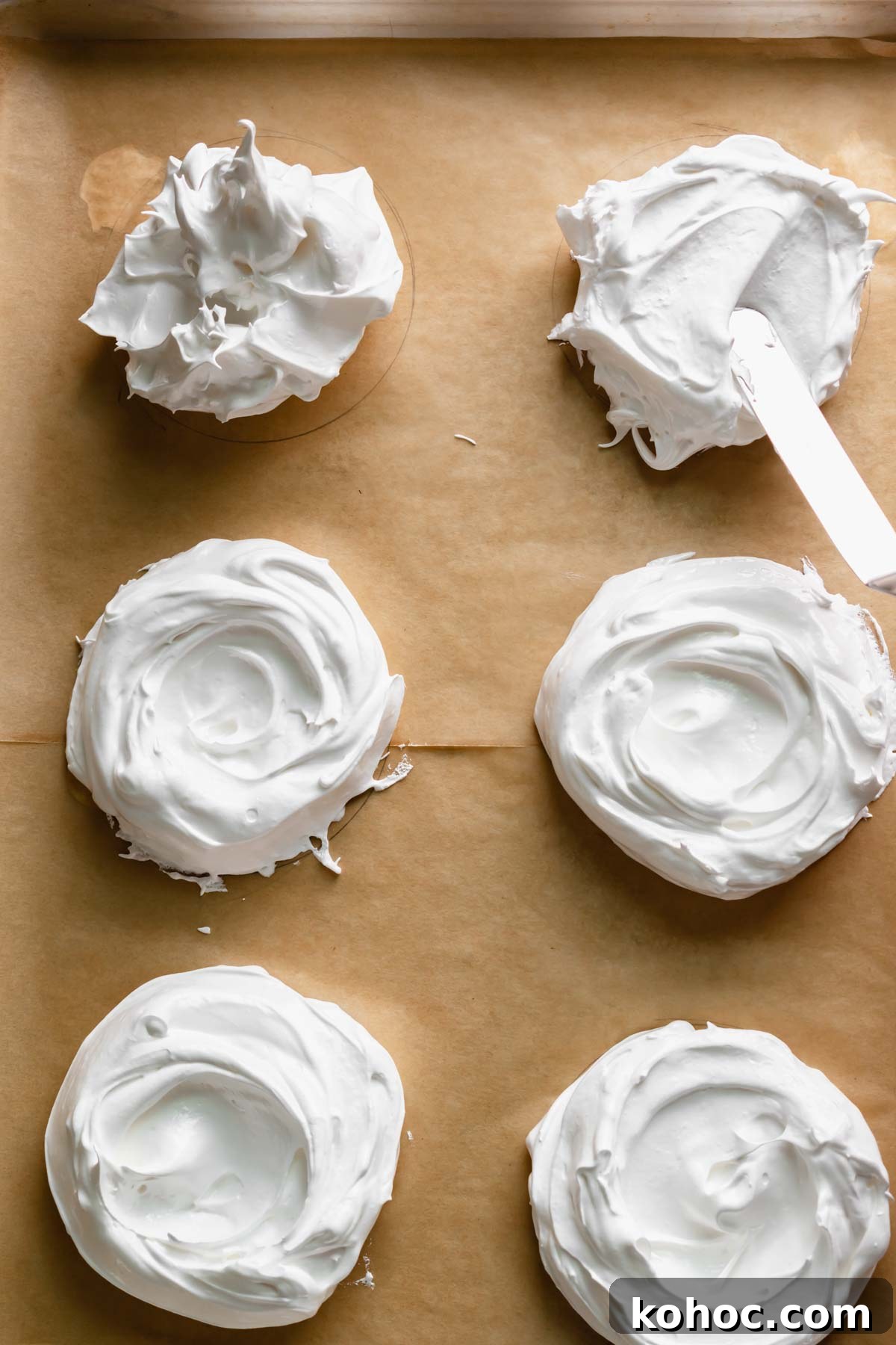 An offset spatula moves the meringue down into circles and makes swoops in the center.