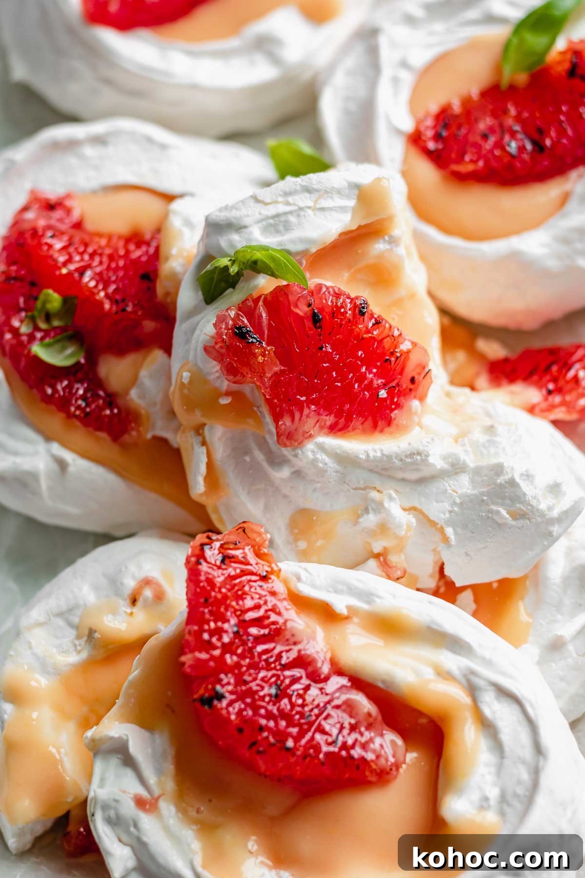 A pile of mini pavlovas with one broken sitting on top.