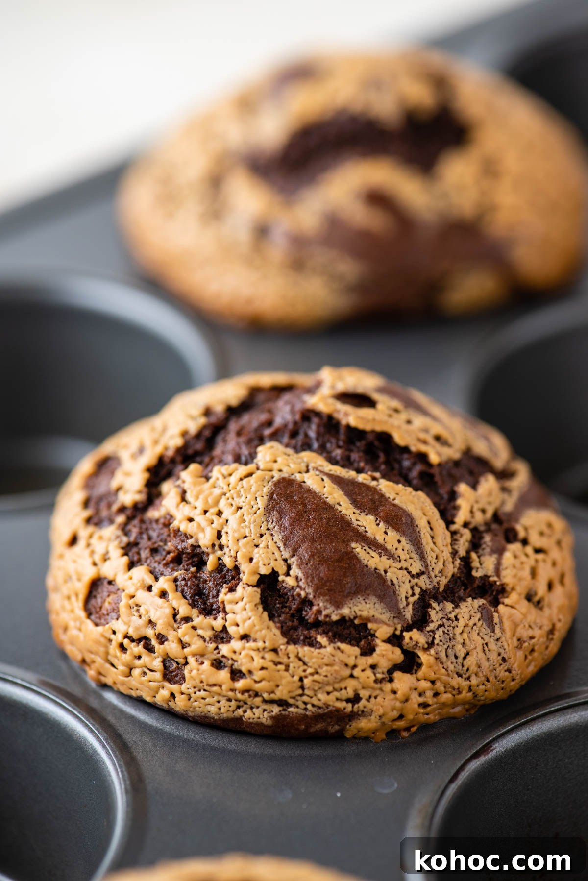 close up of chocolate peanut butter muffins in a muffin tin