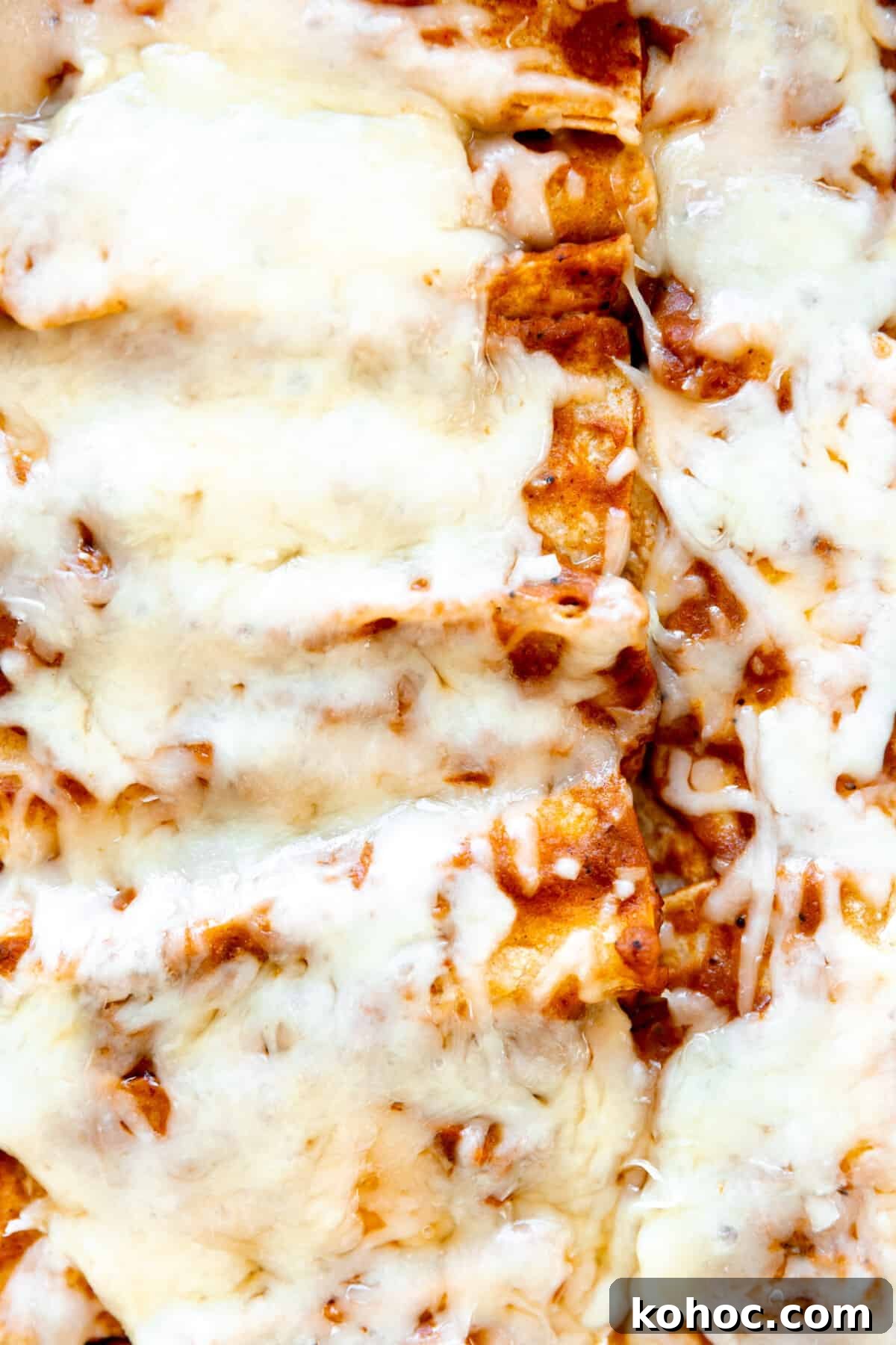 Tex-Mex Cheese Enchiladas with Melted Cheddar and Salsa Verde 6 Tex Mex cheese enchiladas topped with extra melty cheese after baking.