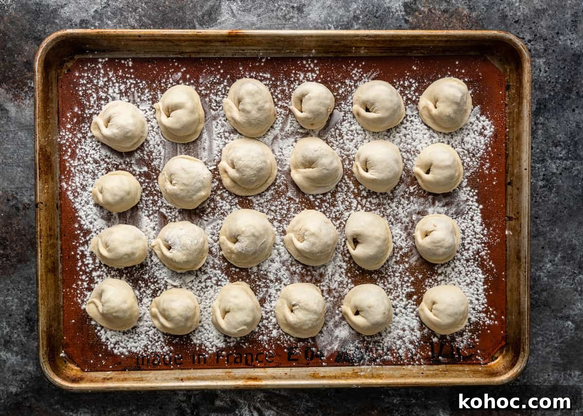 Shish Barak: Lebanese Lamb Dumplings in Yogurt Sauce 11 overhead: tray filled with ready to cook shish barak recipe