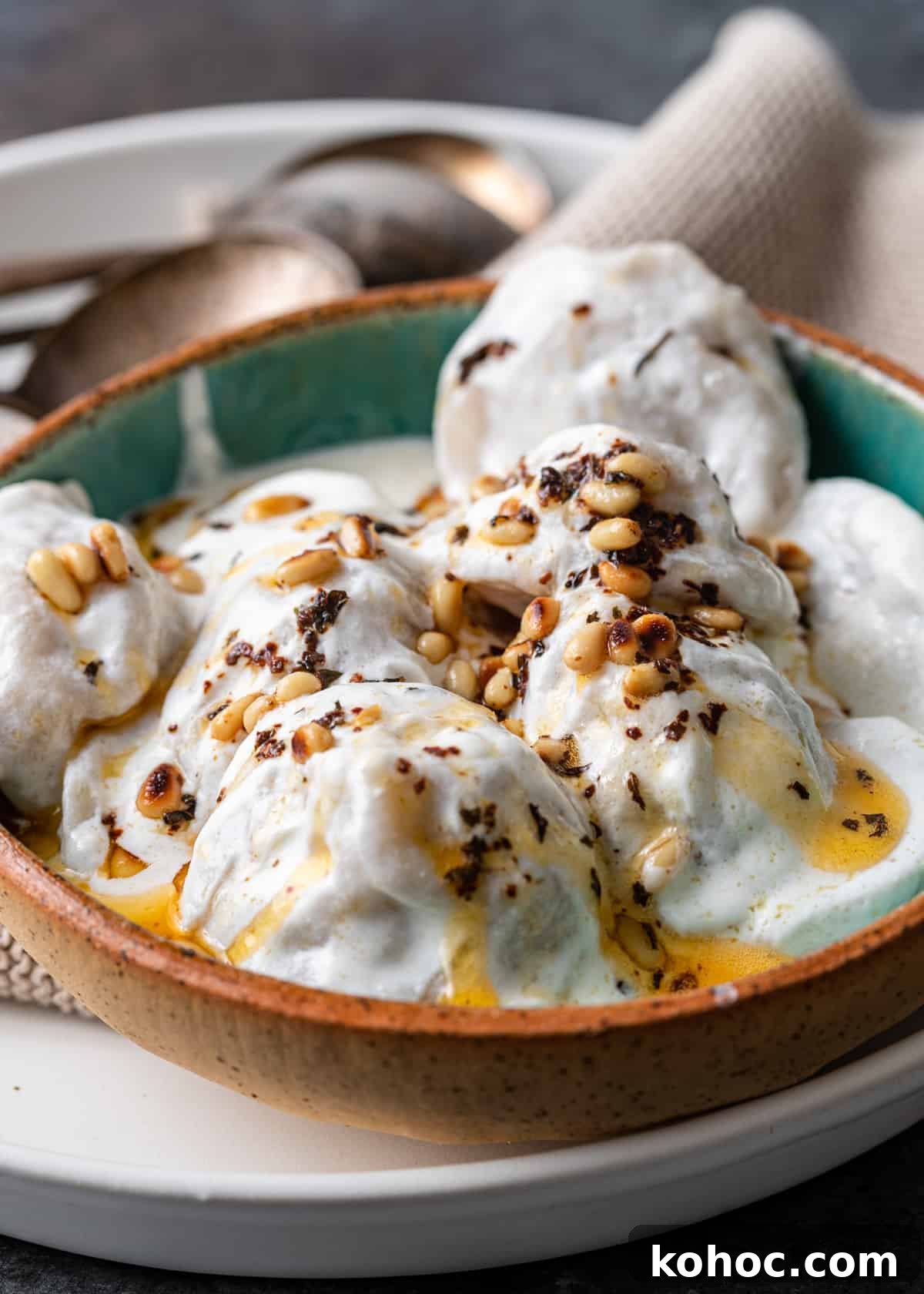 Shish Barak: Lebanese Lamb Dumplings in Yogurt Sauce 15 closeup: bowl with lebanese meat dumpling covered in yogurt sauce