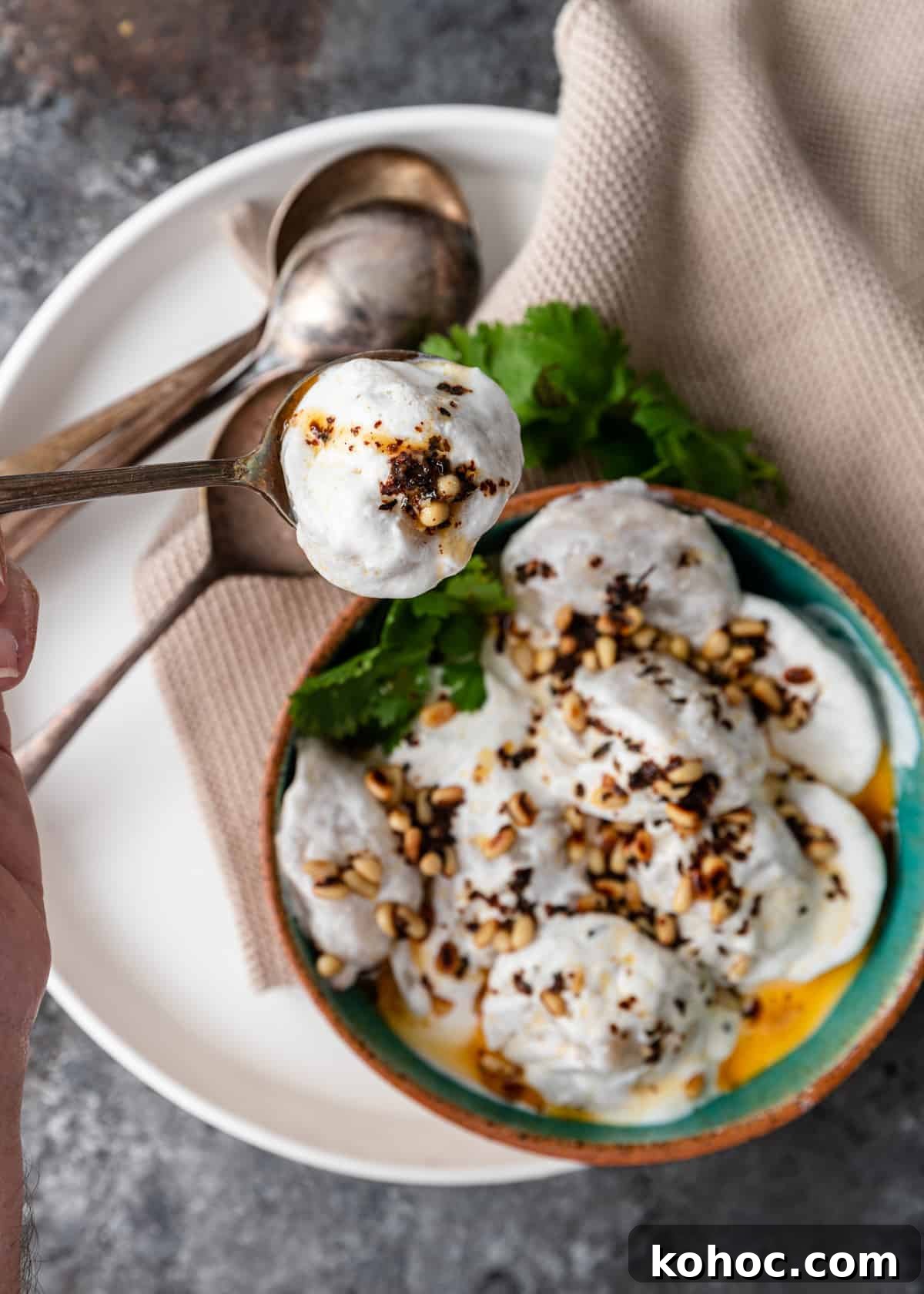 Shish Barak: Lebanese Lamb Dumplings in Yogurt Sauce 16 overhead lebanese meat dumpling in spoon with yogurt sauce