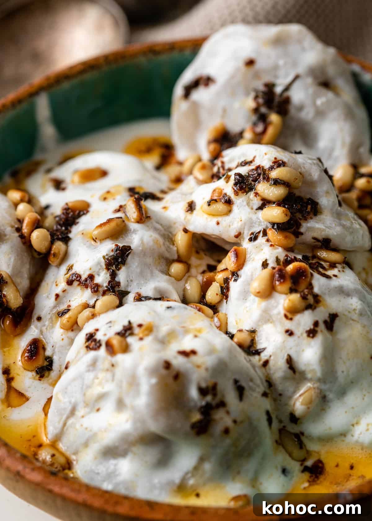 Shish Barak: Lebanese Lamb Dumplings in Yogurt Sauce 3 closeup: shish barak recipe with pine nuts on top