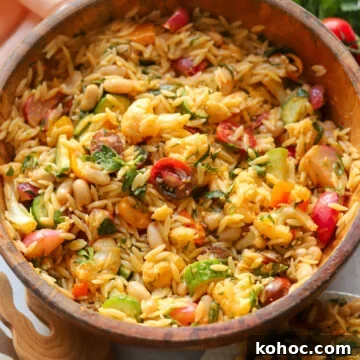 Mediterranean White Bean and Orzo Salad with Lemon Vinaigrette 5 white bean and orzo salad in a wooden bowl with lots of fresh veggies.