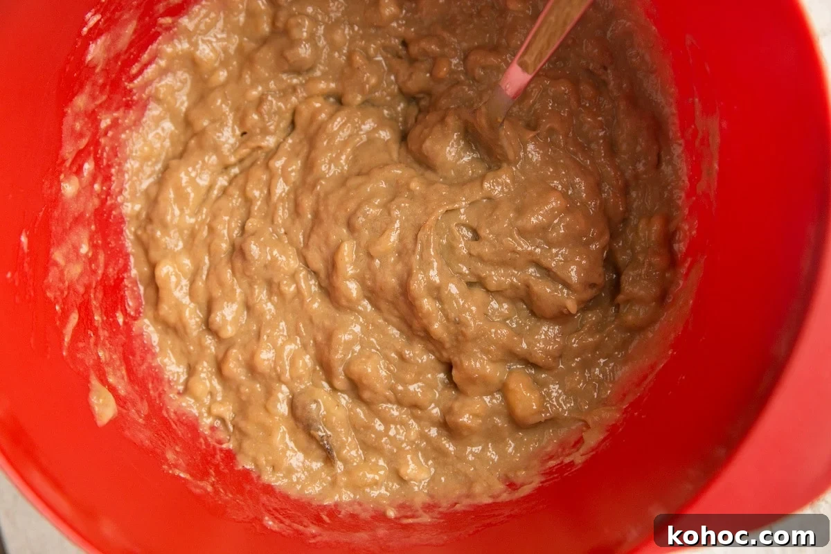 4-Ingredient Banana Oatmeal Bars Recipe for Quick Snacks 6 Mashed banana and almond butter mixed together in a mixing bowl