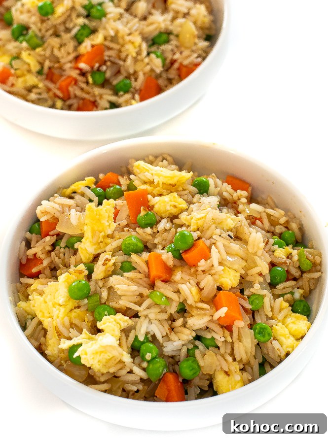 Perfect Instant Pot Fried Rice Recipe for Quick Weeknight Meals 11 White bowl filled with fried rice with another bowl in the background.