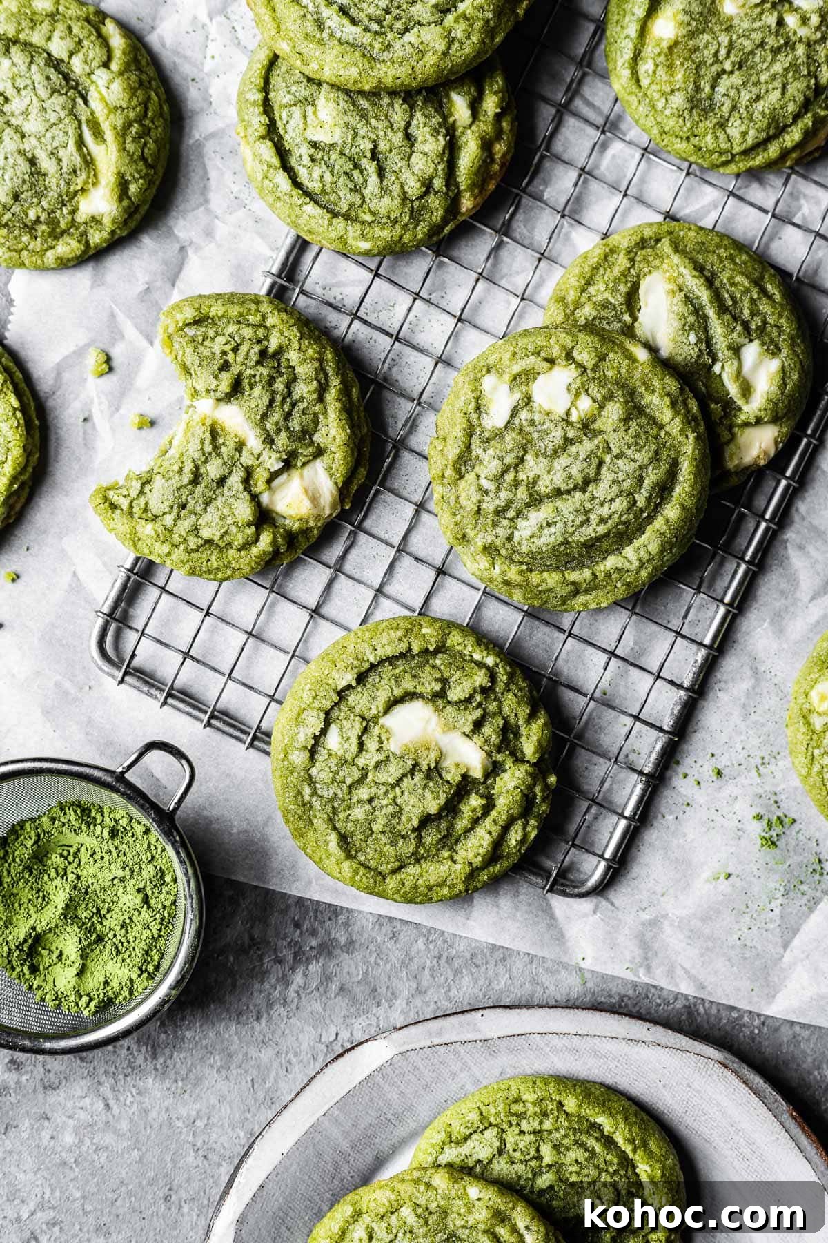 Matcha White Chocolate Cookies Recipe for Soft, Chewy Treats 11 Green matcha white chocolate cookies on a cooling rack resting on white parchment paper.
