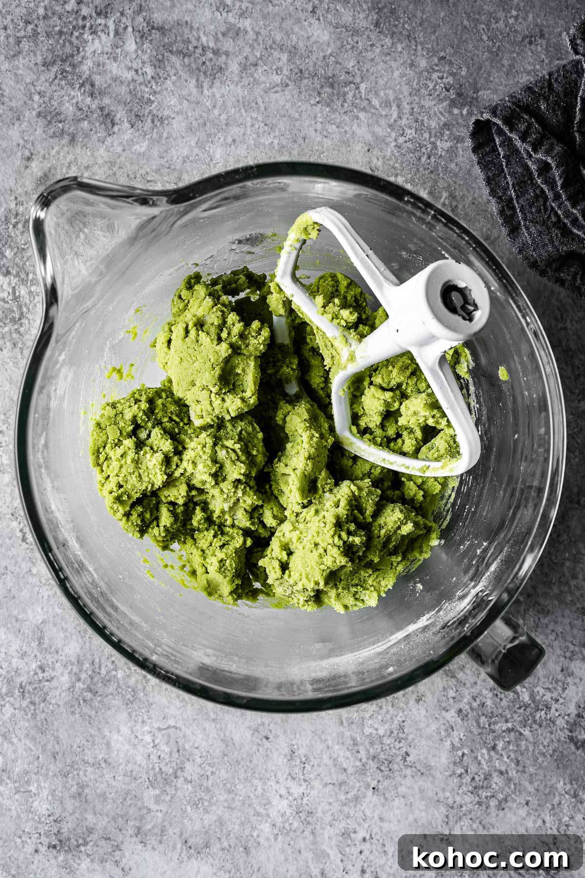 Matcha White Chocolate Cookies Recipe for Soft, Chewy Treats 7 Green matcha cookie dough in a mixing bowl.