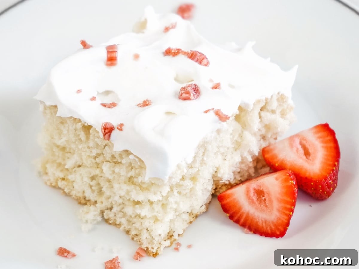 Simple Sheet Cake Recipes for Parties and Weeknight Desserts 2 cream soda cake slice on a plate with strawberries