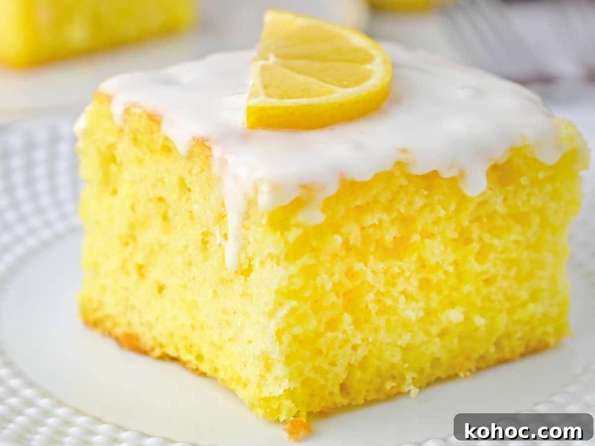 Simple Sheet Cake Recipes for Parties and Weeknight Desserts 11 slice of Lemon Cake with glaze on white plate