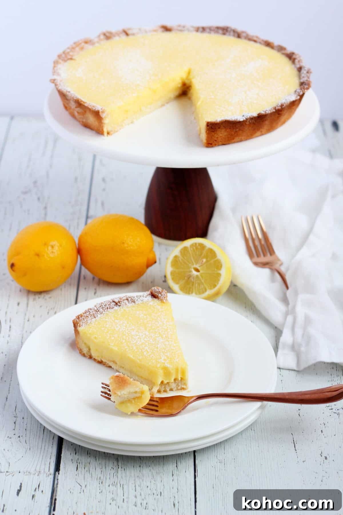 Classic French Lemon Tart Recipe: Authentic Pâtisserie-Style Guide 14 Lemon tart slice with fork and lemons