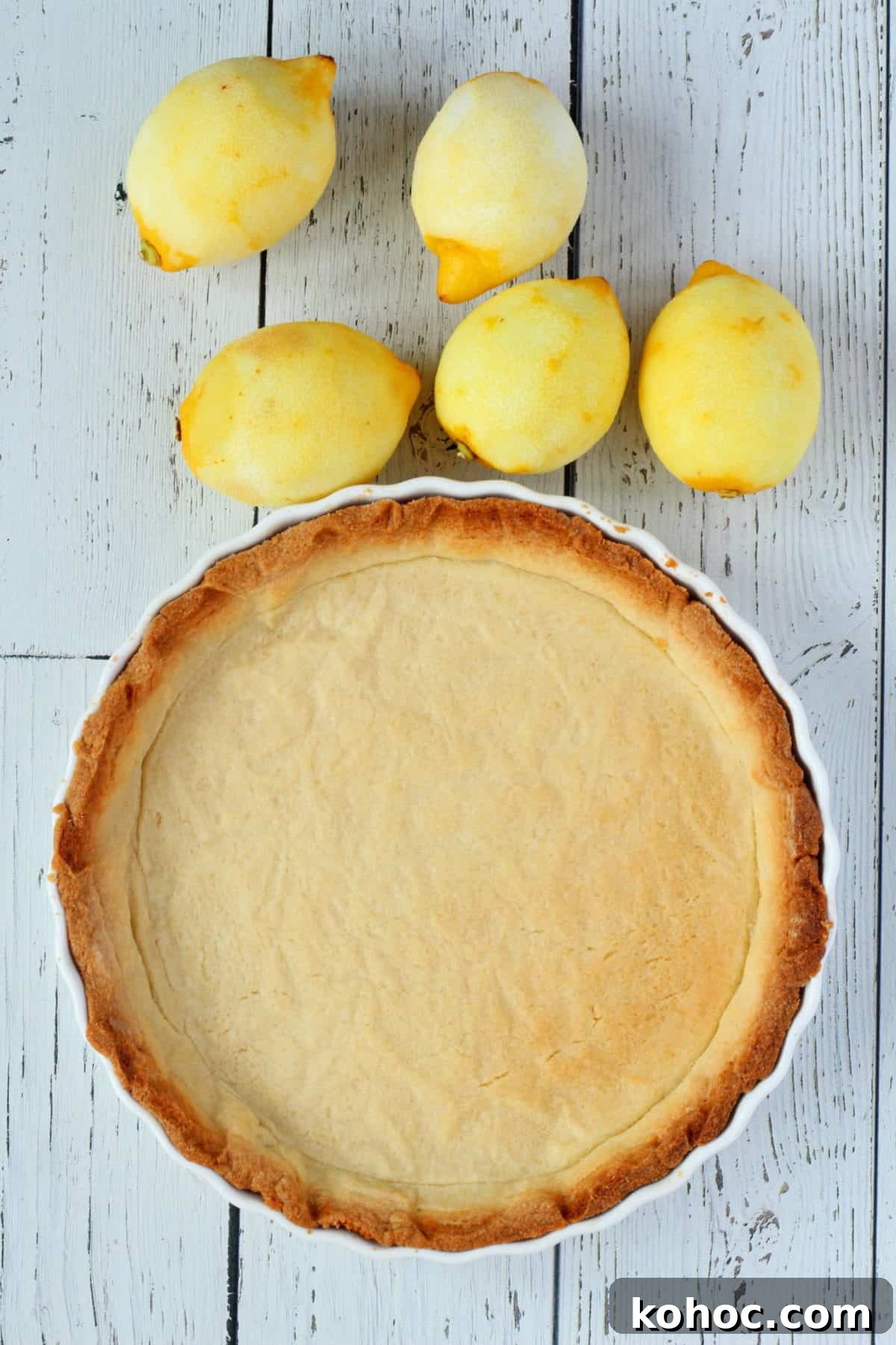 Classic French Lemon Tart Recipe: Authentic Pâtisserie-Style Guide 3 Lemon tart sprinkled with sugar in white dish