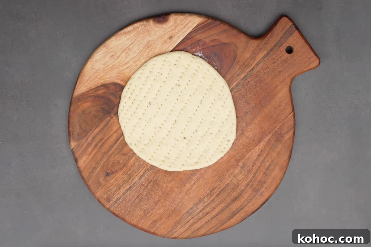Authentic Bakarkhani Recipe: Flaky Bengali Bread Step-by-Step 13 Roti pricked with a fork all over.
