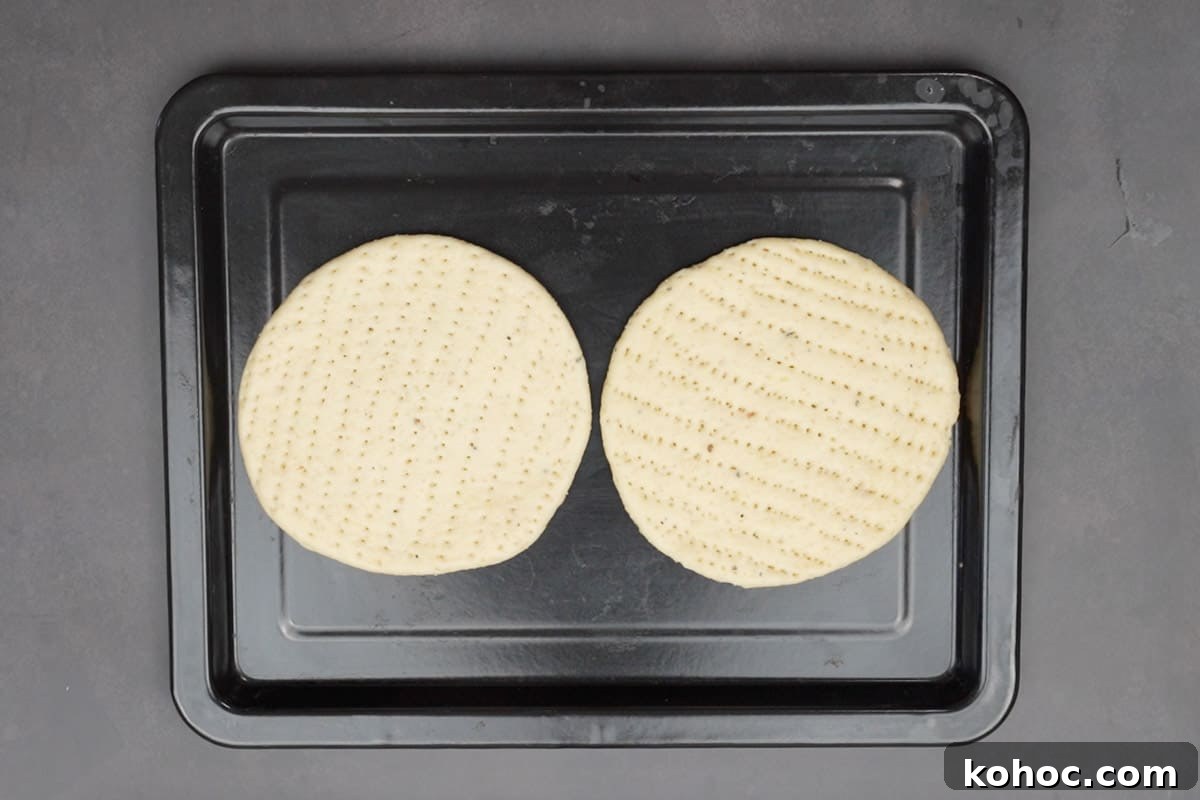 Authentic Bakarkhani Recipe: Flaky Bengali Bread Step-by-Step 14 Roti arranged on a baking tray.