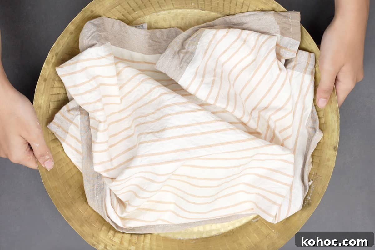 Authentic Bakarkhani Recipe: Flaky Bengali Bread Step-by-Step 6 Dough covered with a cloth.