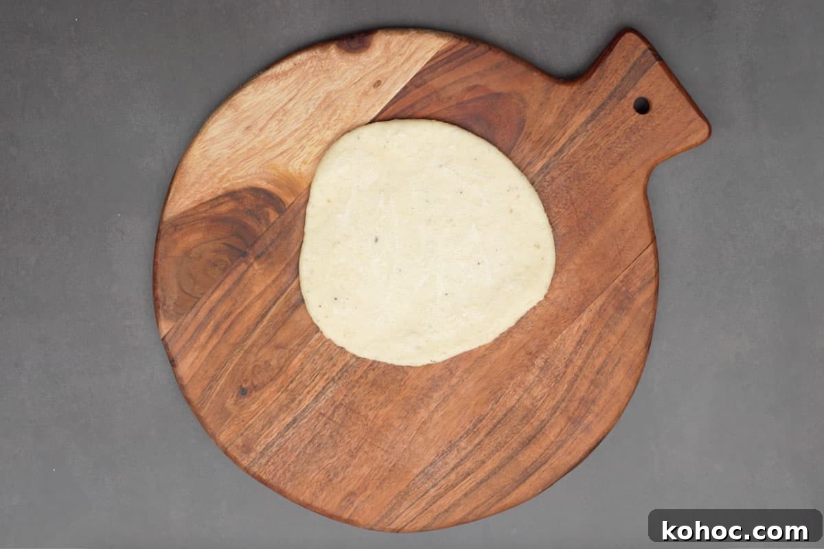Authentic Bakarkhani Recipe: Flaky Bengali Bread Step-by-Step 9 Ghee brushed over 4 inch dough circle.